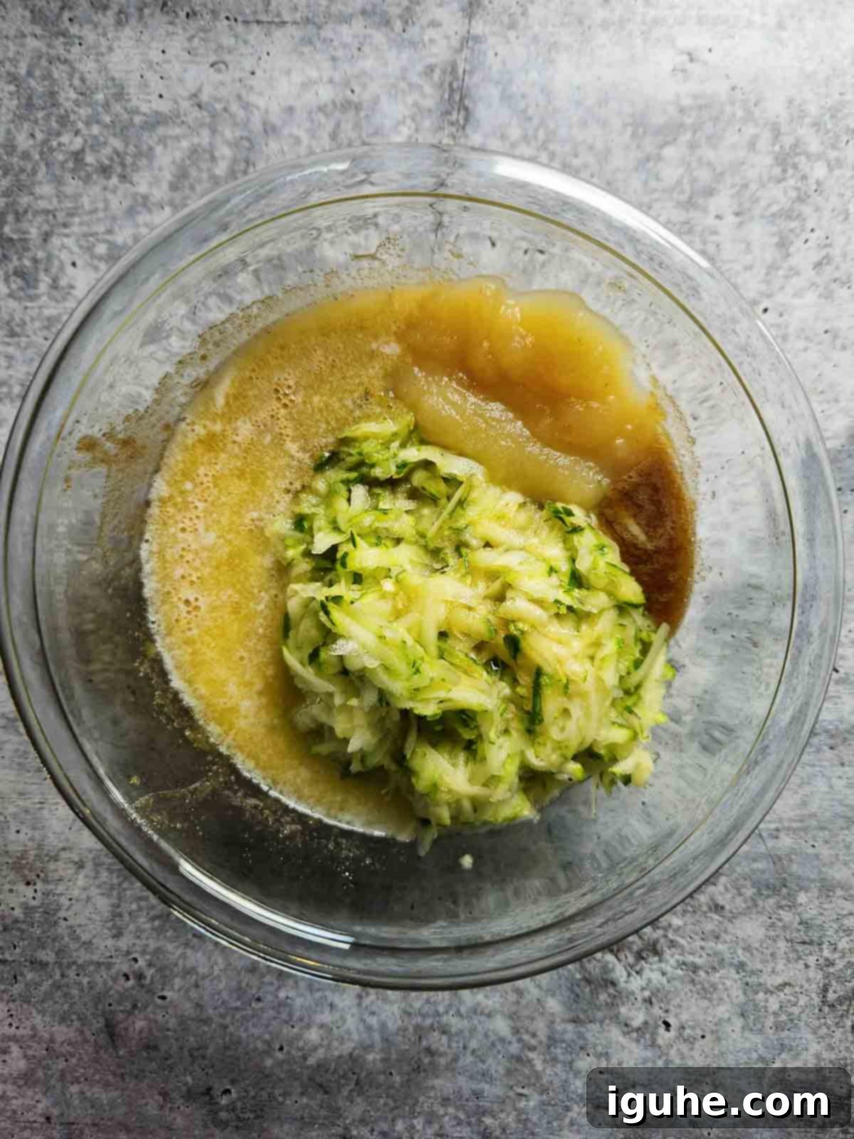 Apple-Kissed Zucchini Muffins 7 Wet ingredients in a bowl for muffins.