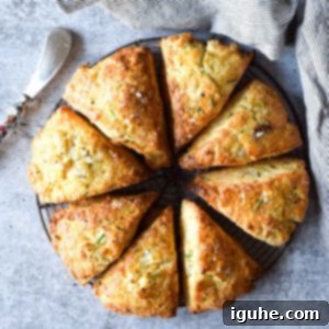 Savory Smoked Gouda and Chive Scones 11 Overhead view of smoked gouda and chive scones cut in eight triangles on a concrete gray background