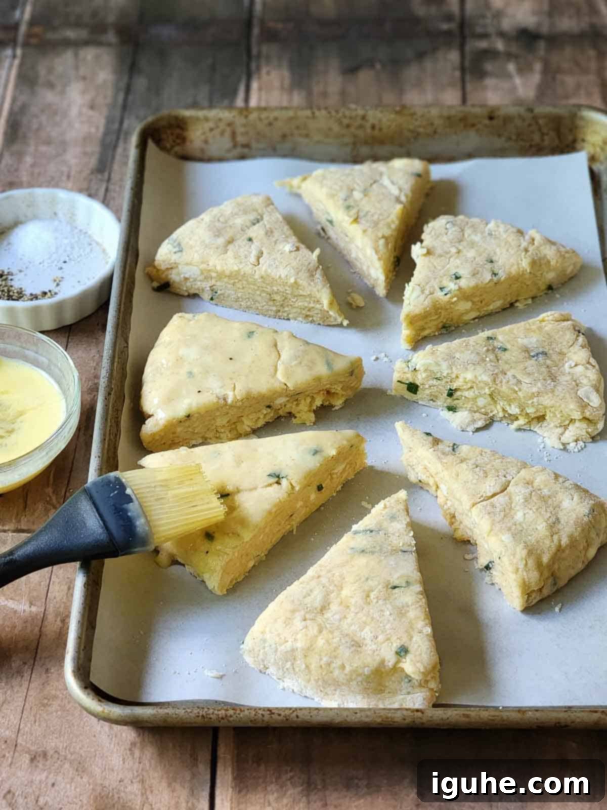 Savory Smoked Gouda and Chive Scones 6 Egg washed being brushed onto scones in a baking pan.