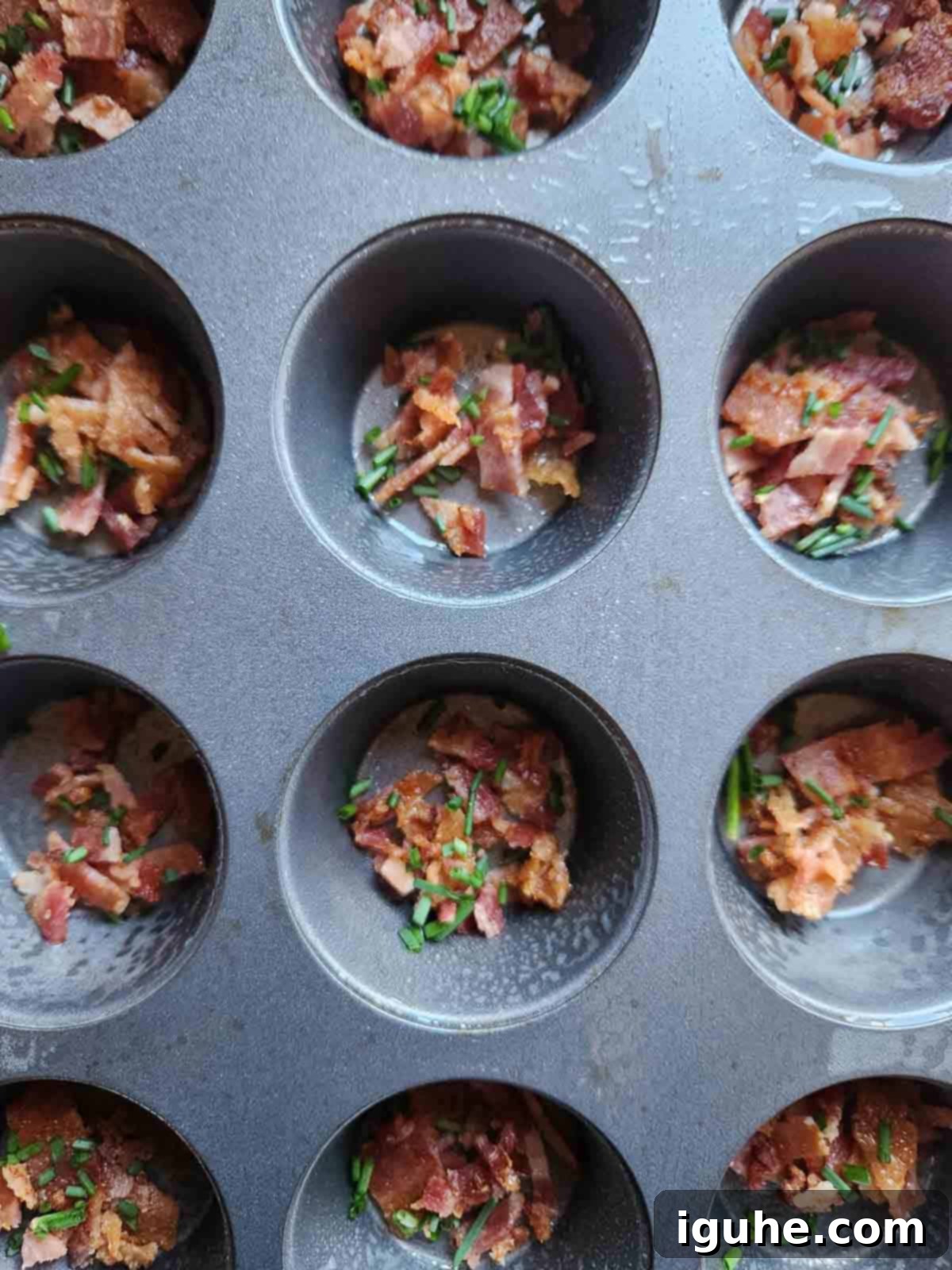 Bacon Buttermilk Egg Bites 6 Bacon and chives in a muffin tin.