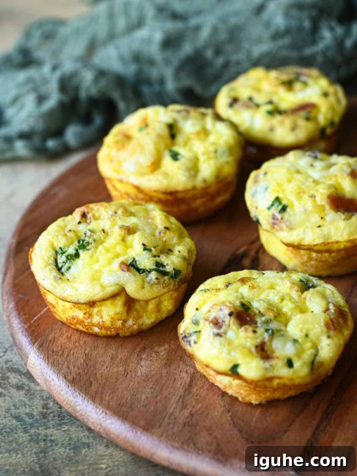 Bacon Buttermilk Egg Bites 8 Five egg bites on a wood board.