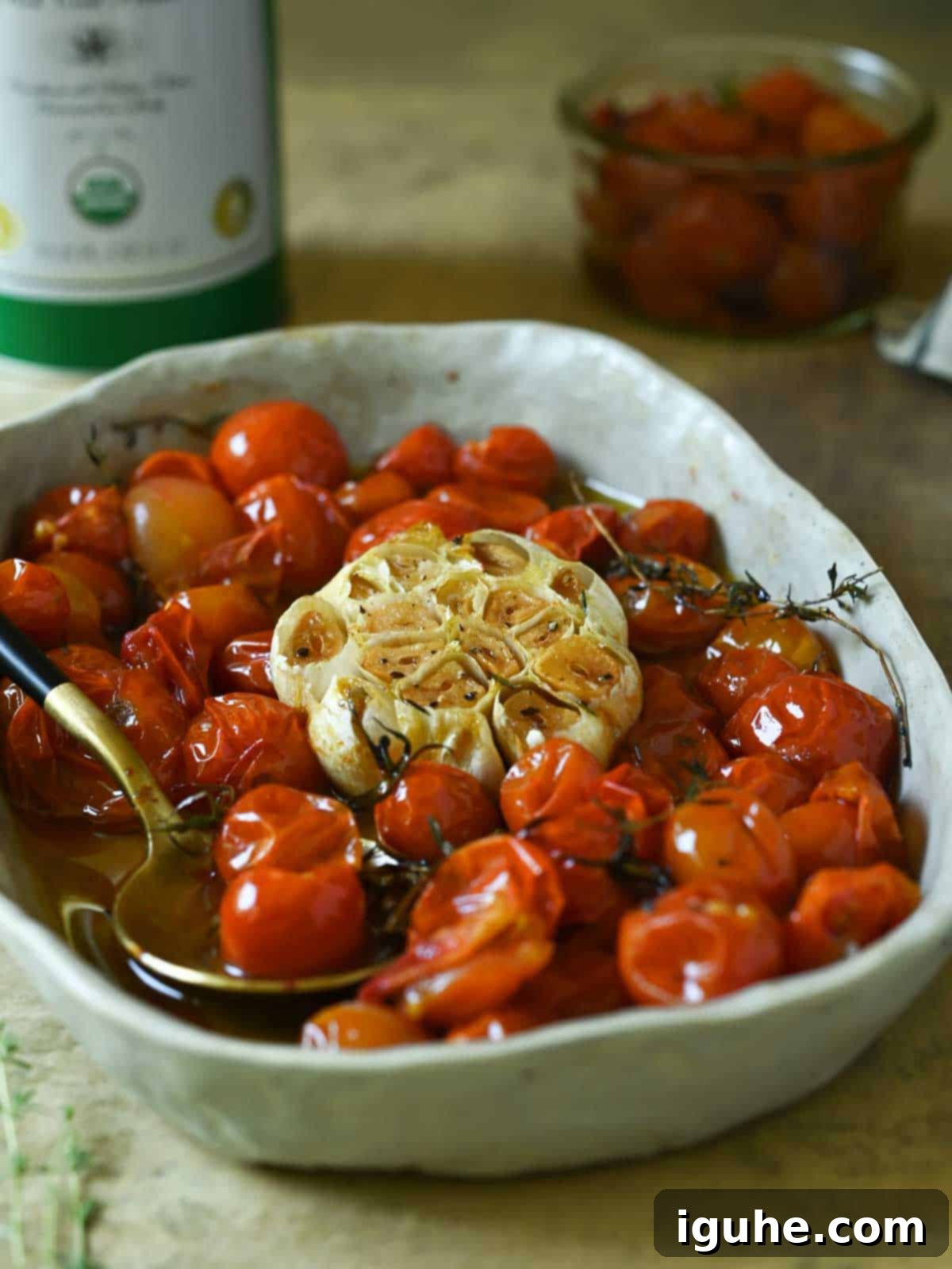 Cherry Tomato Confit with Garlic and Thyme 7 A bowl of cherry tomatoes in oil with garlic.