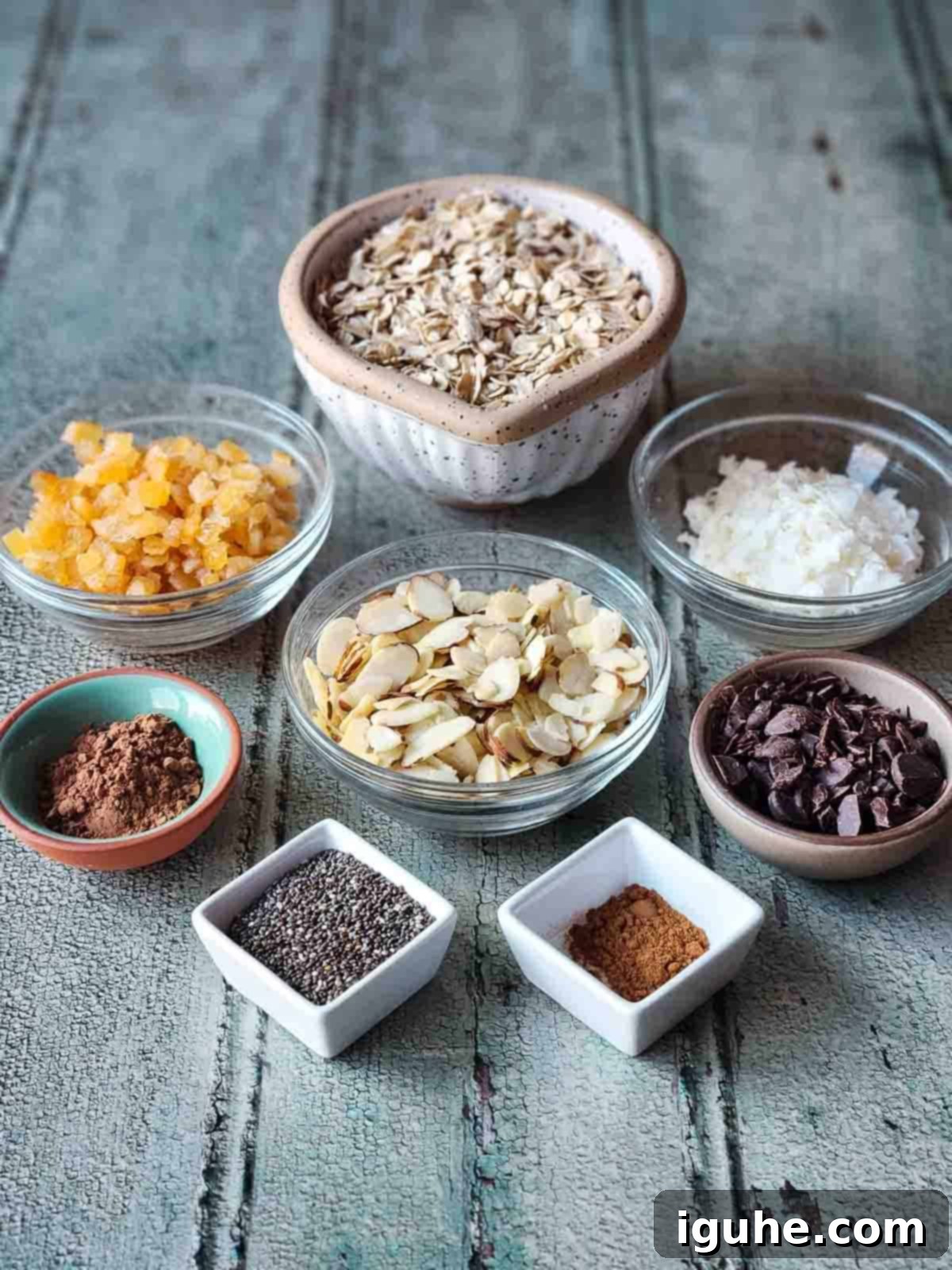 Candied Orange Chocolate Muesli 3 A beautiful flat lay of all ingredients for chocolate muesli laid out on a rustic wooden board, ready for preparation.