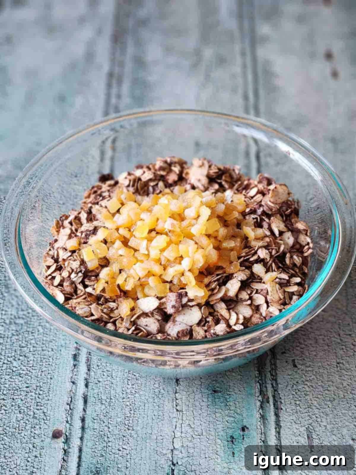 Candied Orange Chocolate Muesli 7 Finished chocolate muesli in a clear bowl, garnished with pieces of candied orange peel.