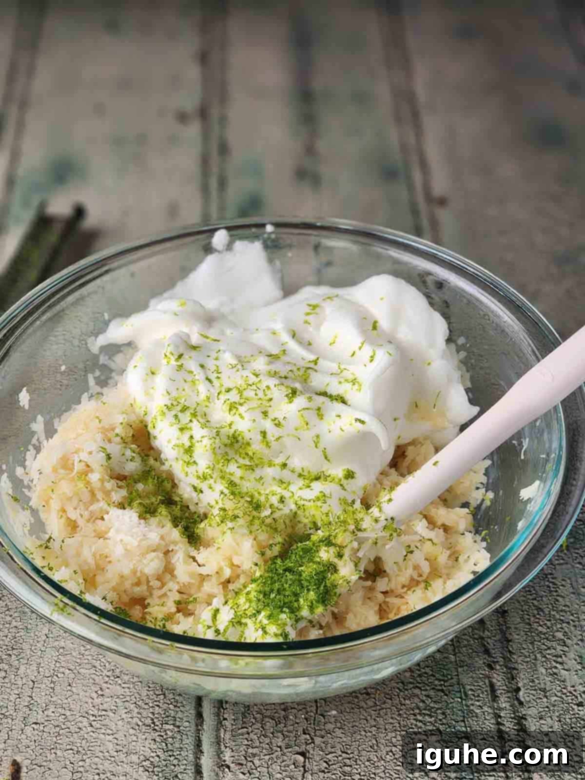 Tropical Coconut Lime Macaroons 7 Egg whites and coconut macaroon batter in a clear bowl, ready for folding.