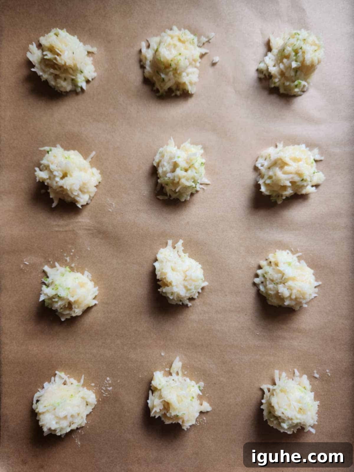 Tropical Coconut Lime Macaroons 9 Dropped mounds of macaroon batter on parchment paper, evenly spaced for baking.