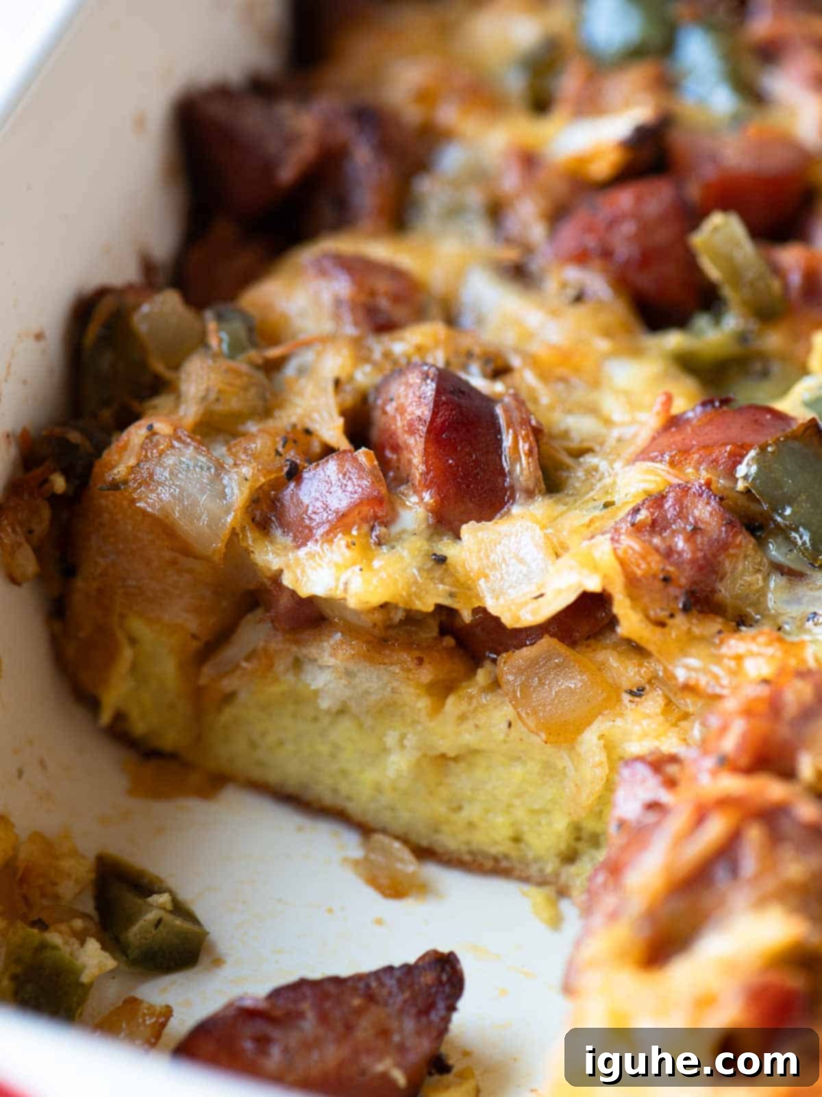 Close-up of a smoked sausage strata in a casserole dish.