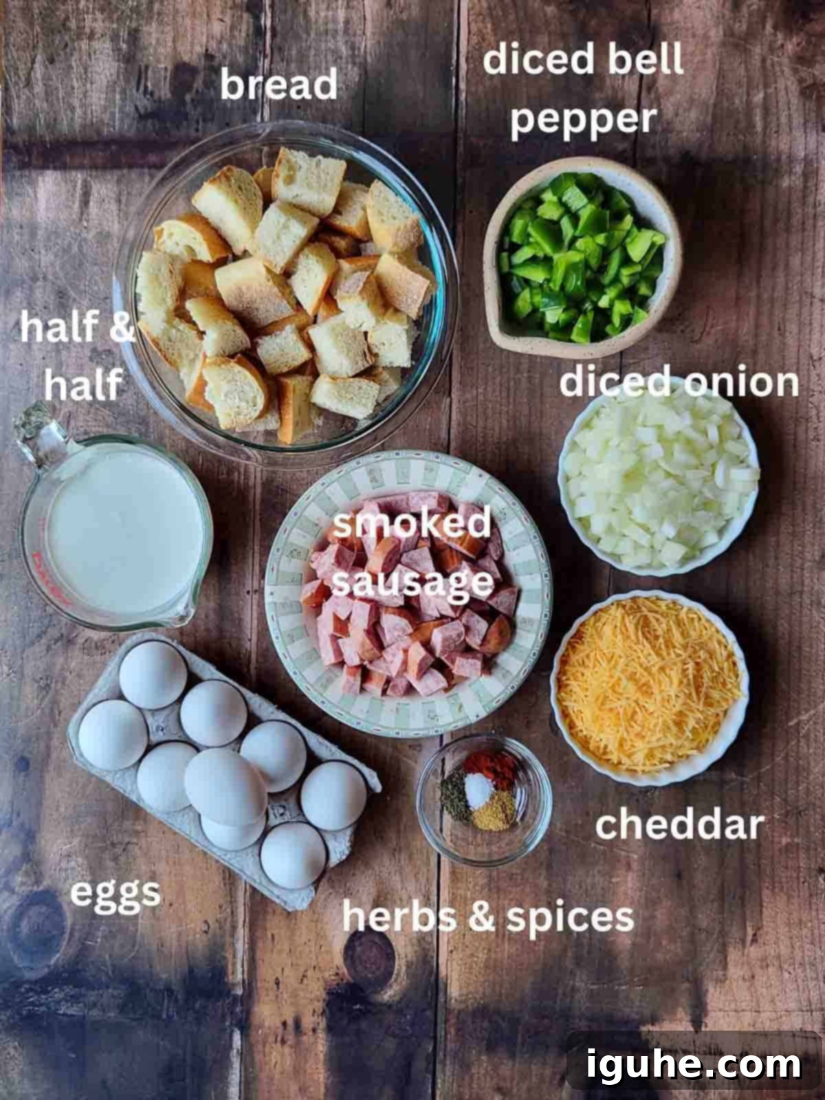 Smoked Sausage Casserole 3 Overhead of ingredients in bowls for a a strata on a wood surface.