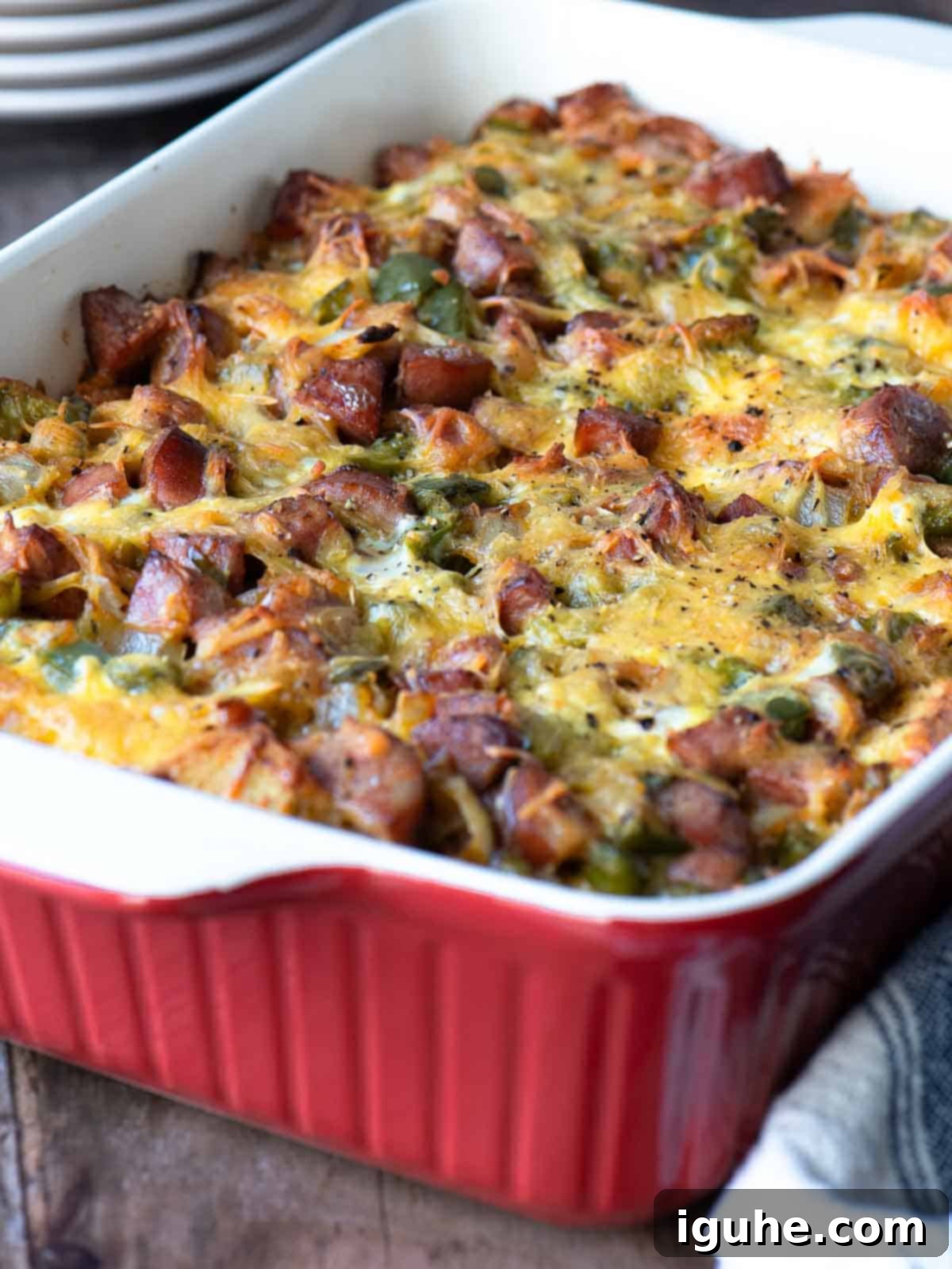 Smoked Sausage Casserole 6 Angled view of a sausage strata in a red baking dish.