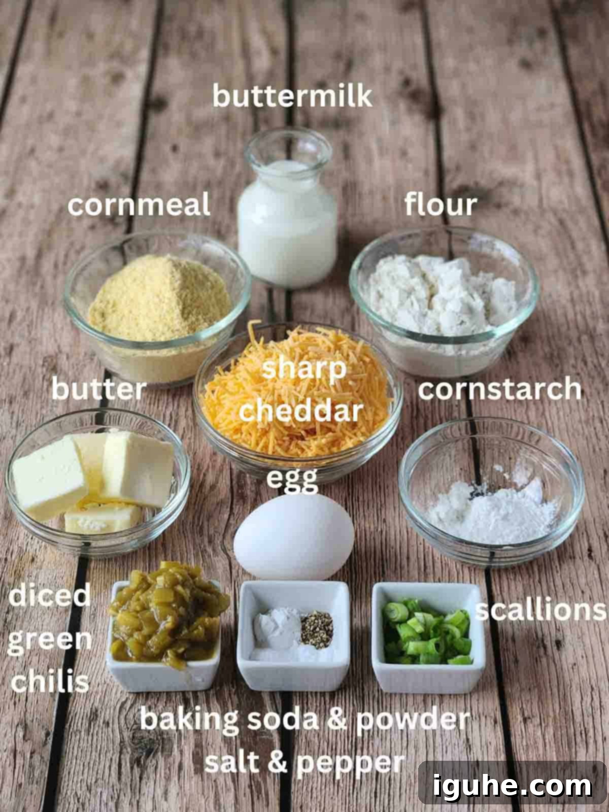 Zesty Cheddar Chili Waffles 3 Labeled ingredients in small bowls for savory waffles on a wood surface.