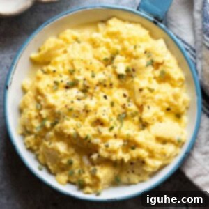 The Ultimate Buttermilk Scramble 10 Overhead close up of scrambled eggs in a blue skillet.