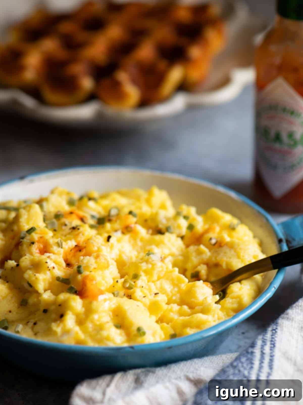 Fluffy Buttermilk Scramble 3 Close up of scrambled eggs with Tobasco sauce on it.