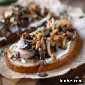 Rustic Wild Mushroom Toast 10 Close up of mushroom toast on parchment paper.