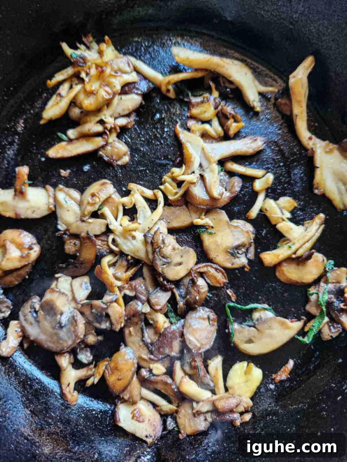Rustic Wild Mushroom Toast 4 Overhead of sautéed mushrooms in a black skillet.