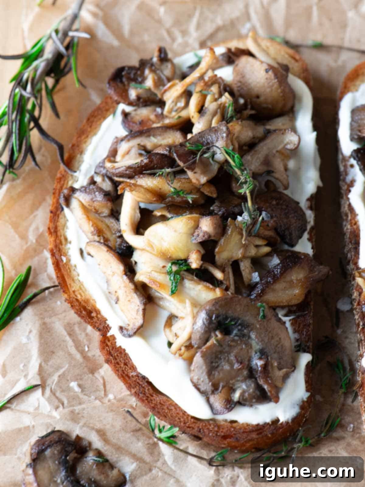 Rustic Wild Mushroom Toast 9 Close-up of mushroom toast with rosemary and thyme on top.