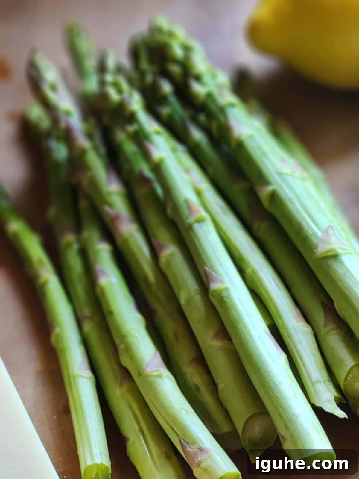 Velvety Asparagus Leek Soup 3 Asparagus spears on a wood board.