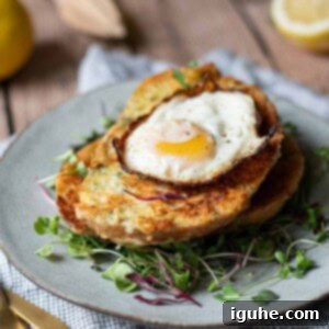 Parmesan, Lemon and Herb Savory French Toast 12 Angled view of savory French toast with a fried egg on top over greens.
