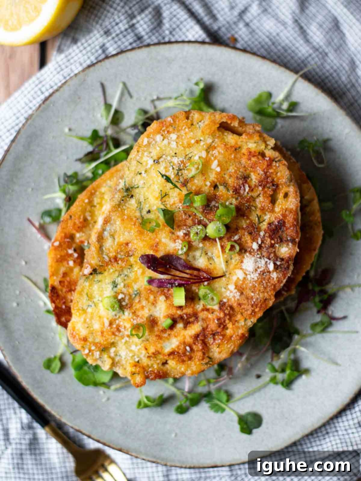 Parmesan, Lemon and Herb Savory French Toast 3 Overhead of savory French toast over a bed of microgreens on a grey plate.