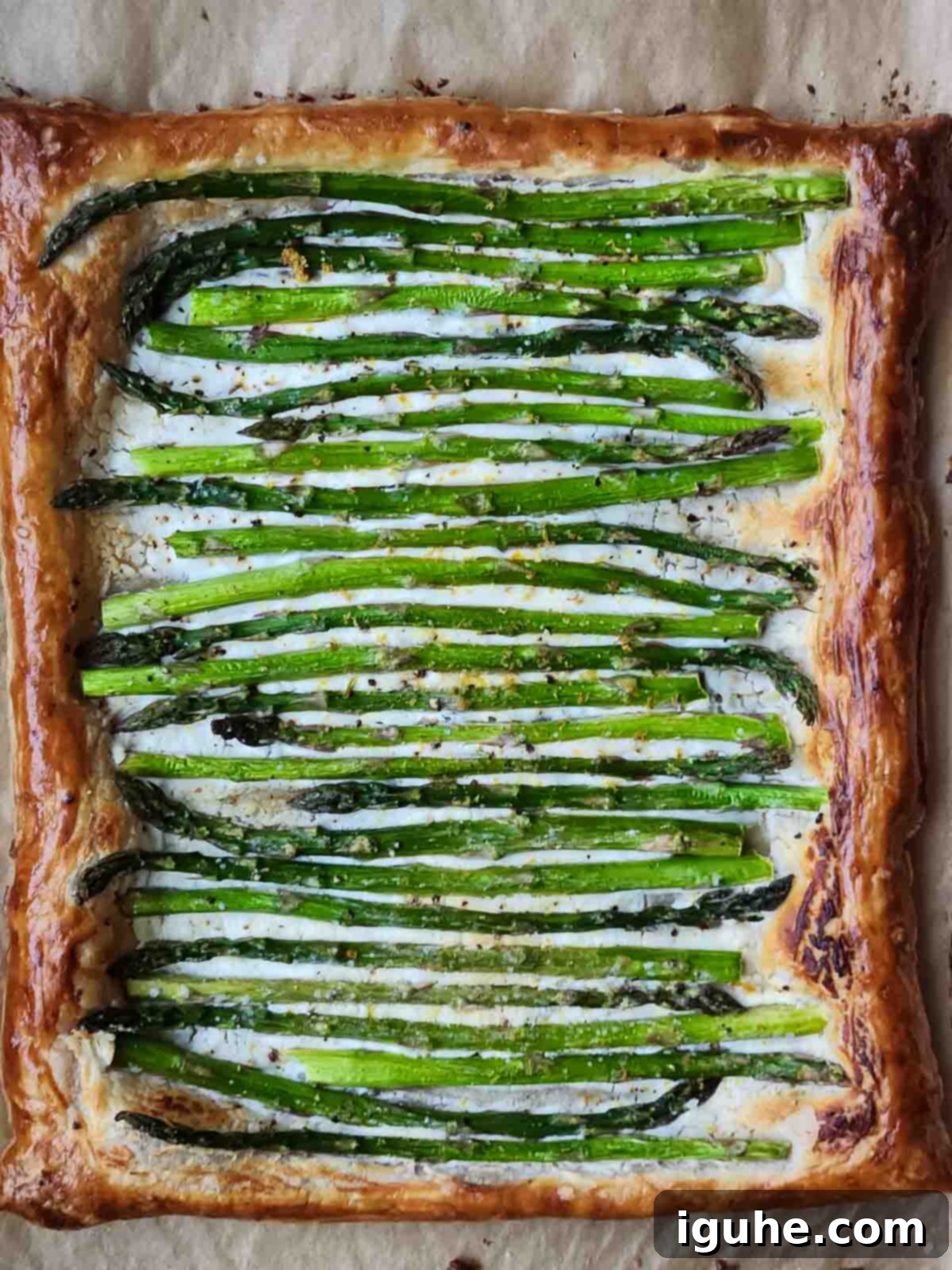 Flaky Asparagus Tart with Tangy Goat Cheese 4 Overhead view of asparagus puff pastry with goat cheese.