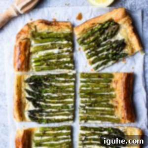 Flaky Asparagus Tart with Tangy Goat Cheese 6 Overhead of asparagus and whipped goat cheese puff pastry tart cut into six pieces with a lemon to the side