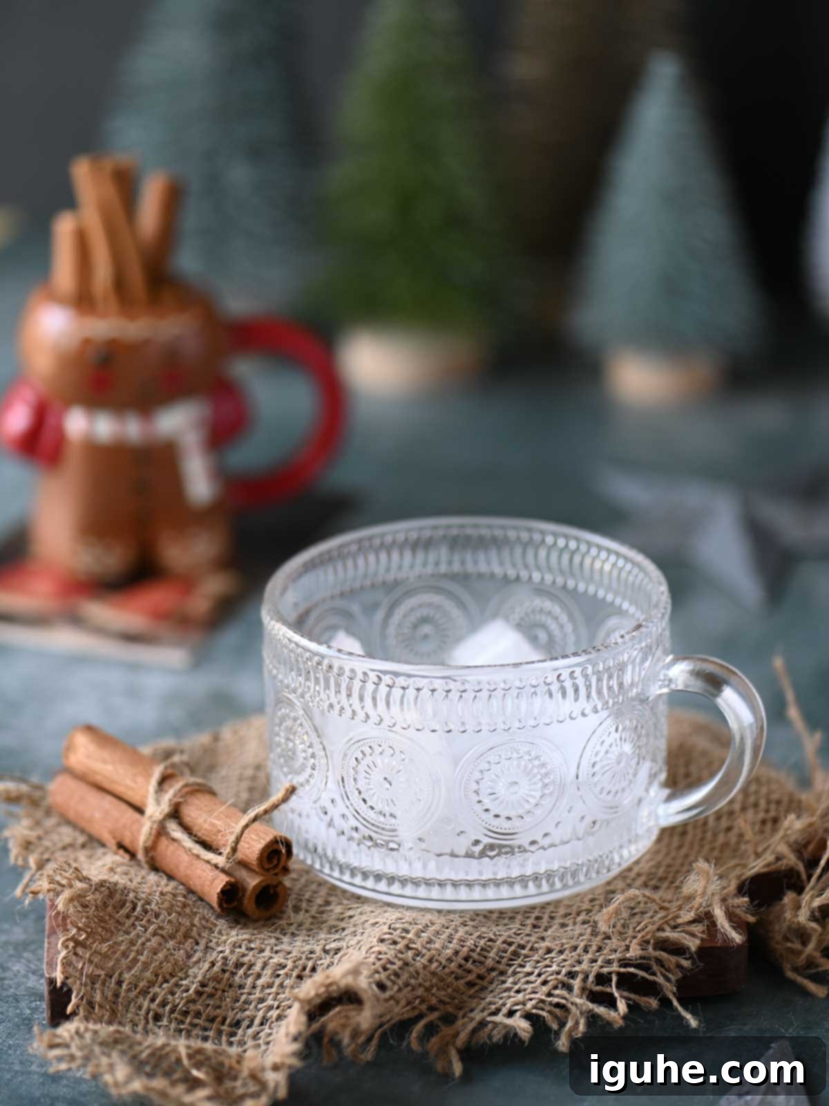 Ice in a clear glass on burlap.