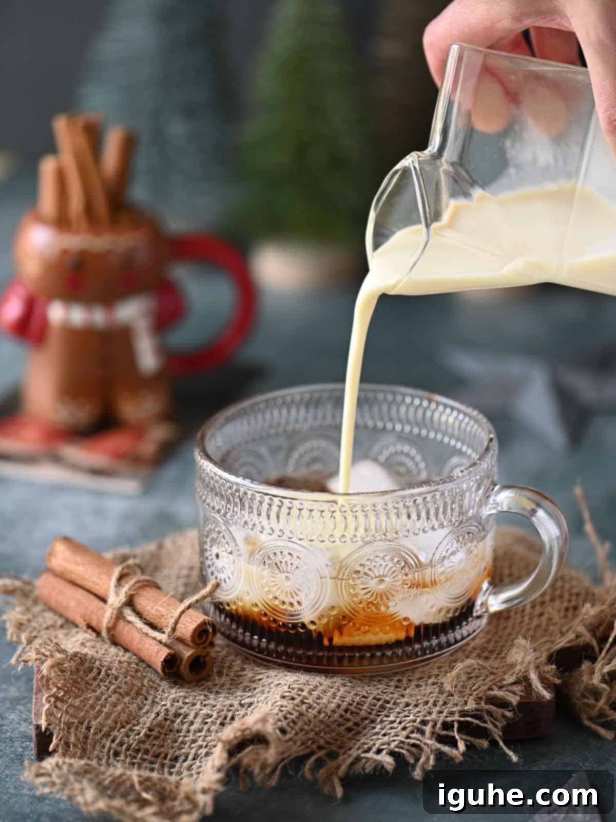 Eggnog being poured into a clear class.