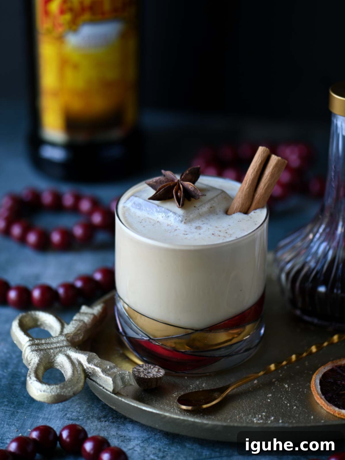 White Russian in a clear glass on a gold tray.
