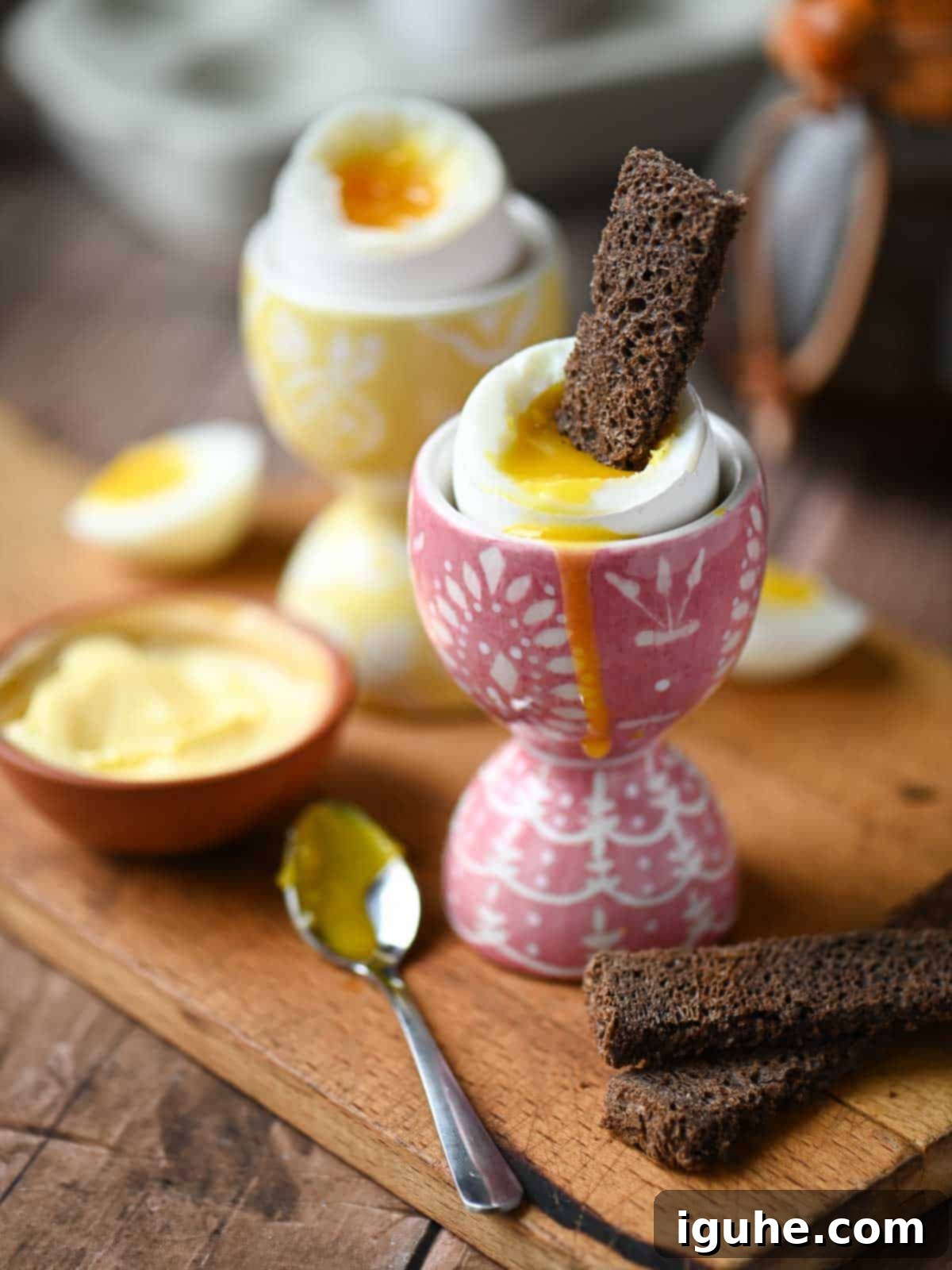 Perfectly Runny Eggs With Toasted Rye 2 A slice of rye toast dipped into a soft boiled egg inside a pink egg holder.