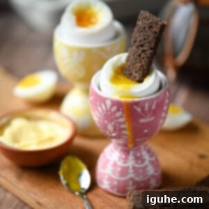 Perfectly Runny Eggs With Toasted Rye 10 Close up of perfectly soft boiled eggs in patterned cups with slices of rye toast ready for dipping.