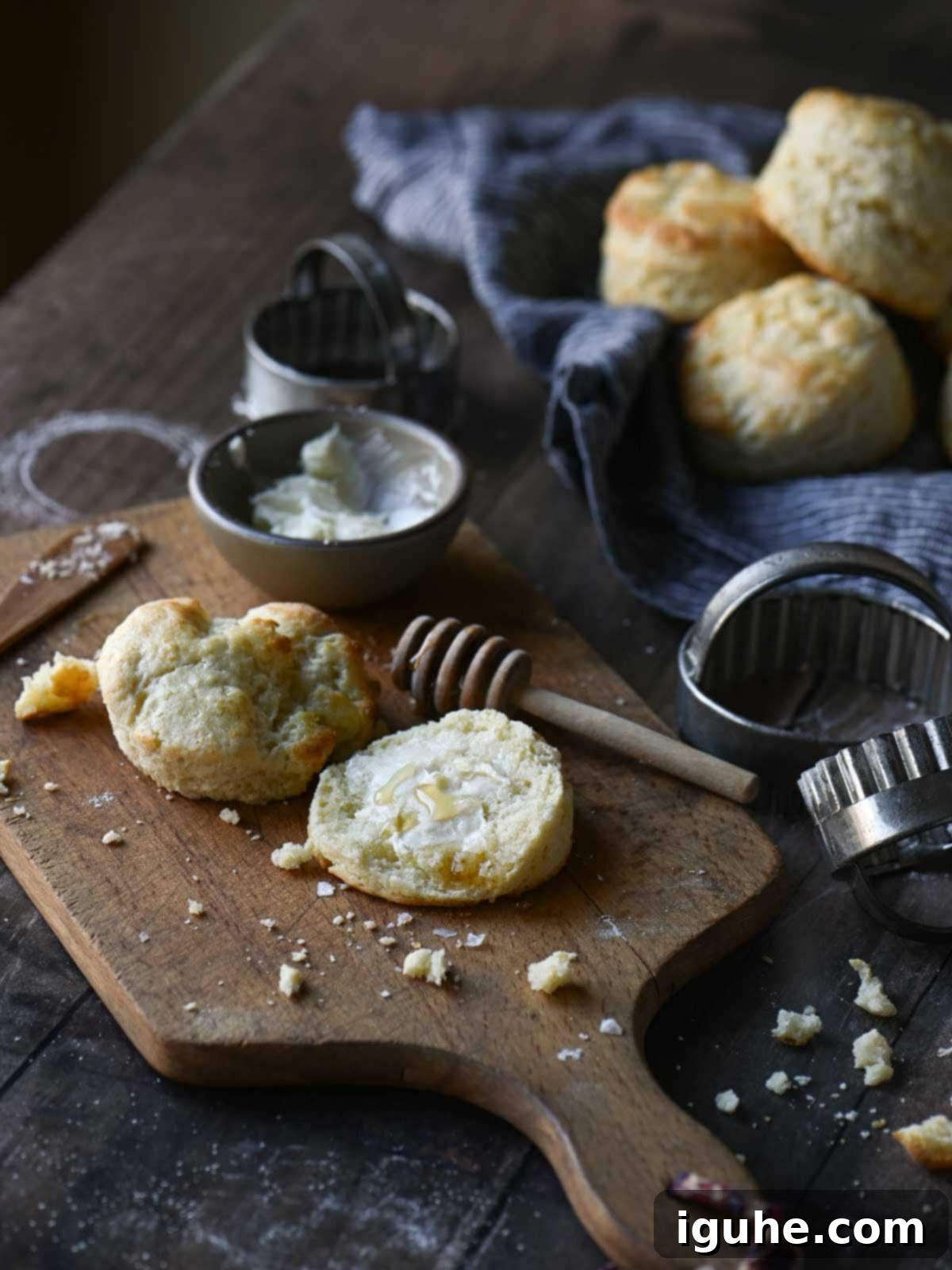 Cake Flour Biscuits 7 An angled view of a breakfast table setting with cake flour biscuits, butter, and crumbs scattered around.