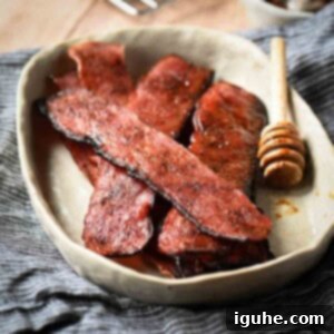 Honey Chipotle Turkey Bacon Bliss 10 A beige bowl with strips of bacon on a blue napkin.