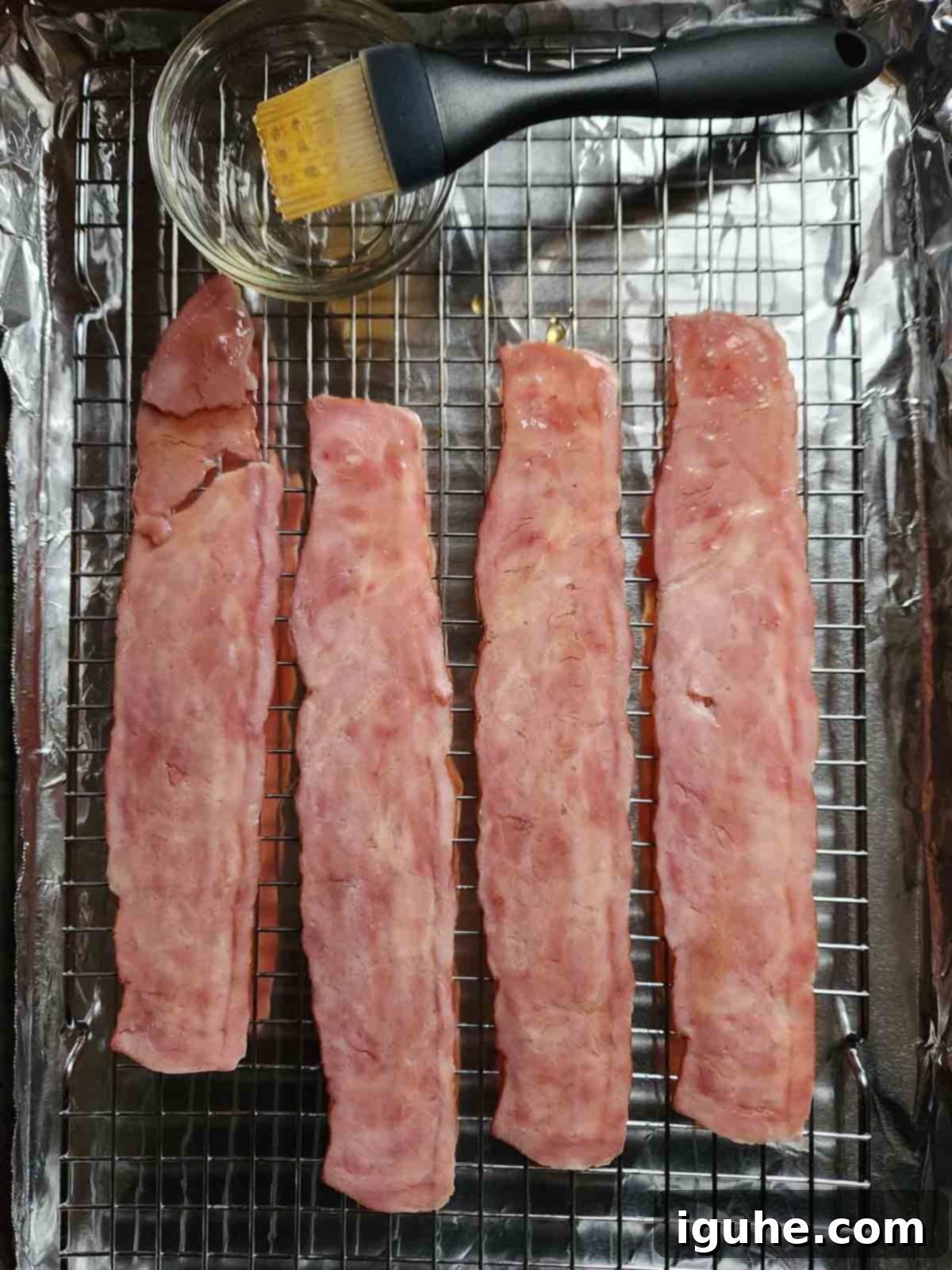 Honey Chipotle Turkey Bacon Bliss 5 Turkey bacon on a wire rack and pan, brushed with a glistening layer of honey.