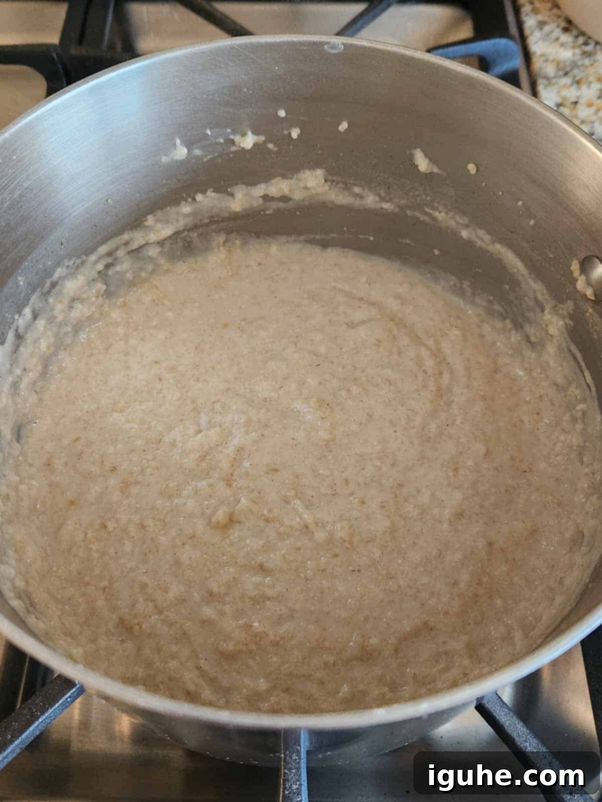 Dates and Honey: A Twist on Classic Scottish Oatmeal 6 Creamy, perfectly cooked oatmeal simmering in a pot on the stove, ready to be served.