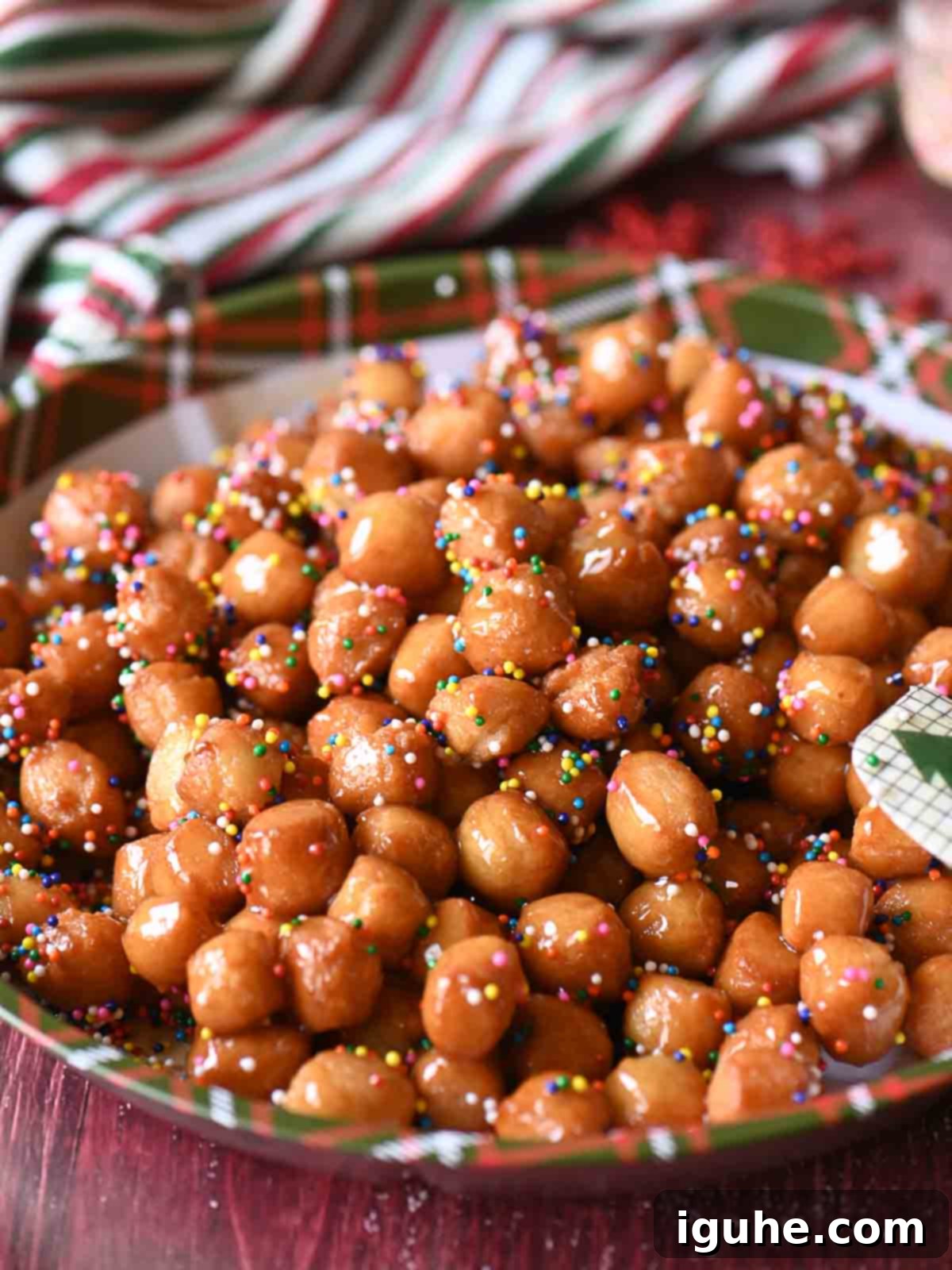 Honey-Drizzled Italian Dough Balls 2 A festive Christmas plate piled high with golden Italian honey balls.