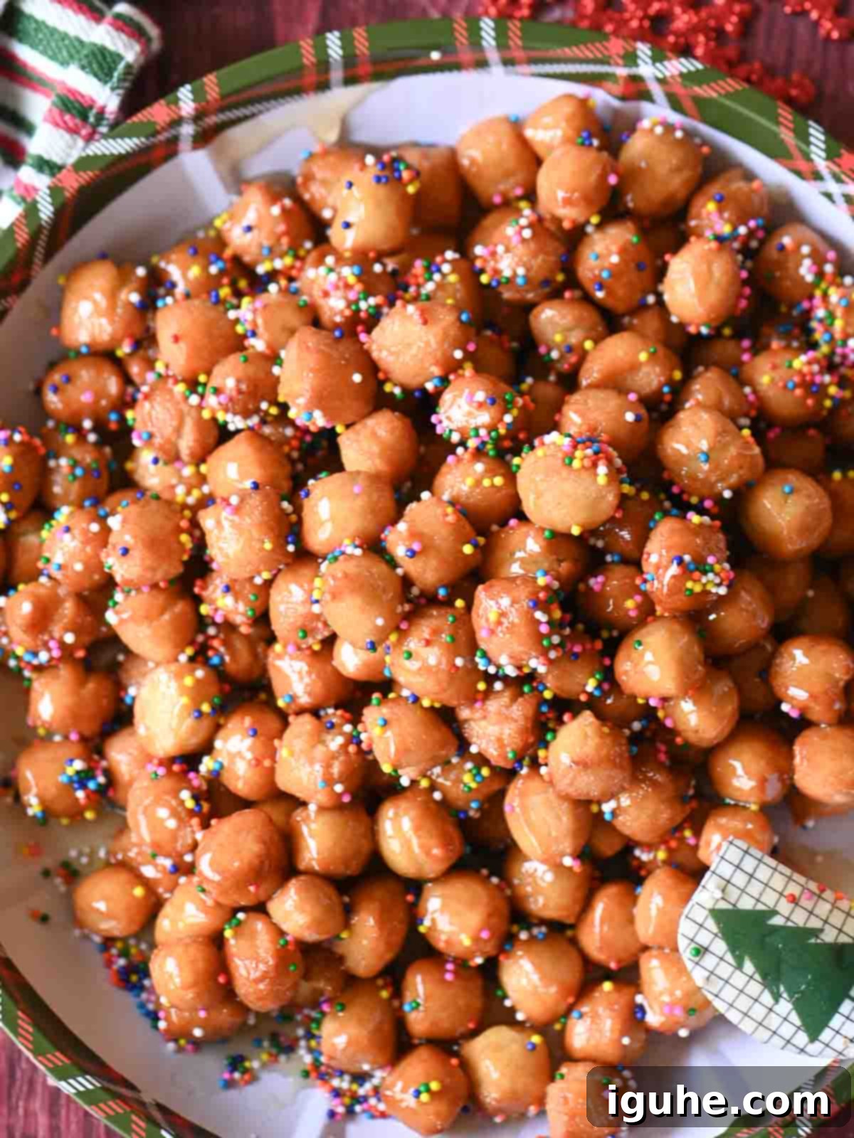 Honey-Drizzled Italian Dough Balls 8 A birds-eye view of beautifully arranged struffoli on a Christmas-themed plate.