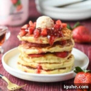 Strawberry Kefir Pancakes
Berry Bliss Kefir Pancakes 7 A stack of strawberry kefir pancakes with jammy strawberries on top.